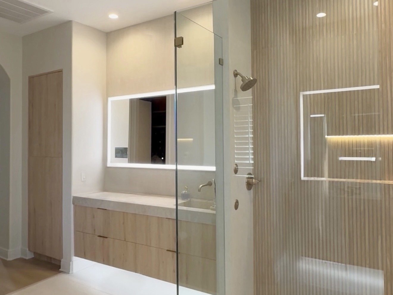 Bath with fluted feature wall and floating vanity