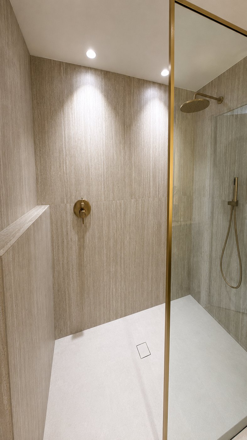 Wood-wall walk-in shower with brass fixtures
