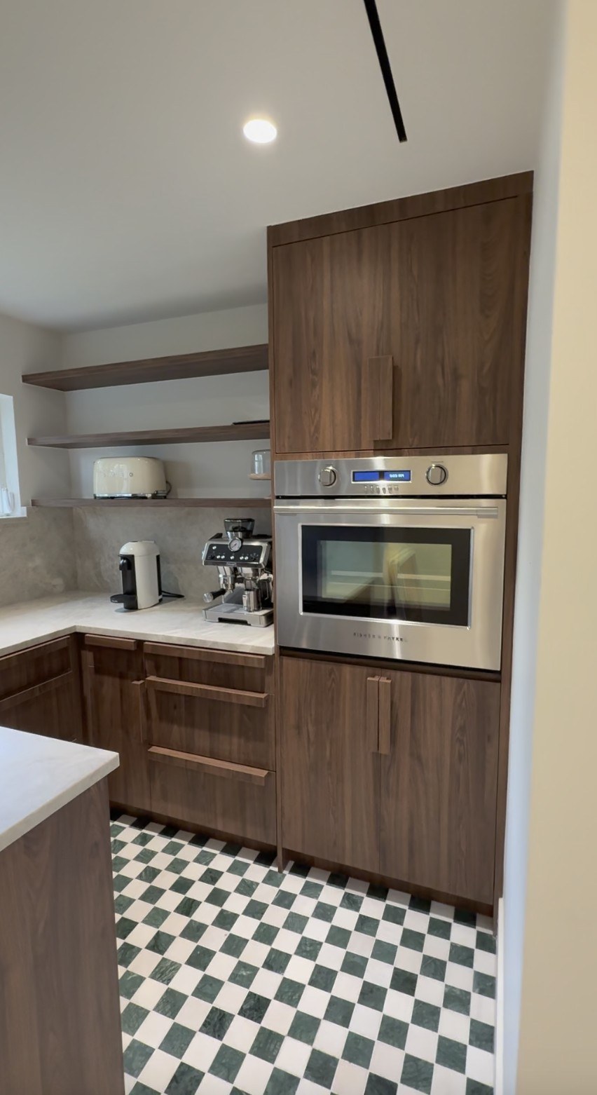 Walnut kitchen with patterned tile floor